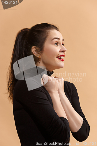 Image of The happy business woman standing and smiling against pastel background.