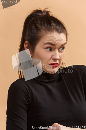 Image of Young woman with disgusted expression repulsing something, isolated on the pastel