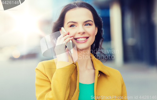 Image of smiling young woman or girl calling on smartphone