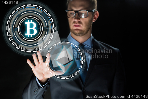 Image of businessman with cryptocurrency holograms