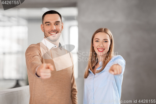 Image of businesswoman and businessman pointing at you