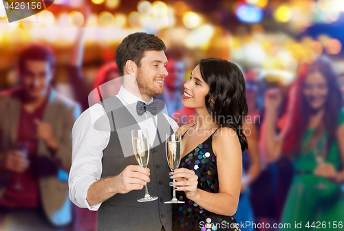 Image of happy couple with champagne glasses at party