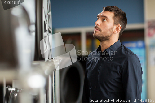 Image of male customer choosing wheel rims at car service