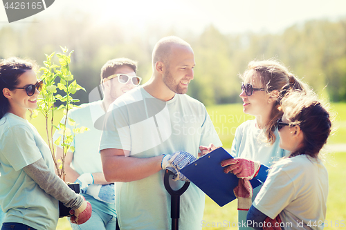 Image of group of volunteers planting trees in park