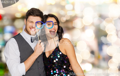 Image of happy couple with party glasses over lights