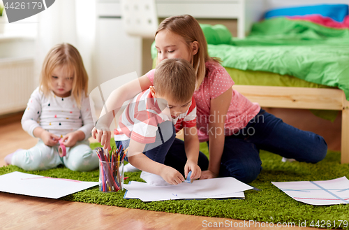 Image of happy kids drawing at home