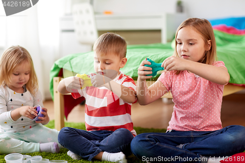 Image of kids with modelling clay or slimes at home