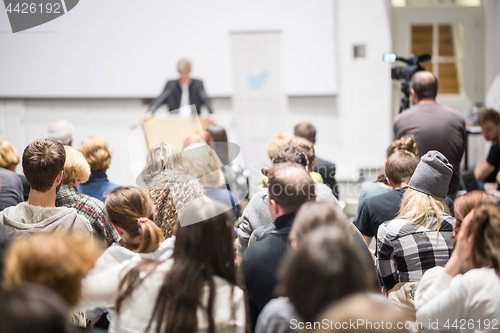 Image of Business speaker giving a talk at business conference event.