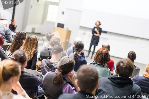 Image of Woman giving presentation in lecture hall at university.