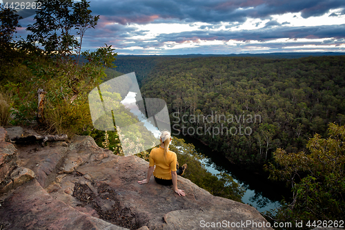 Image of Female enjoying river views from cliff top