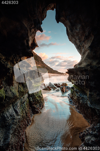 Image of Nature\'s window - sunrise beach cave