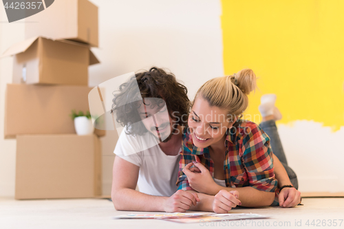 Image of Happy young couple relaxing after painting