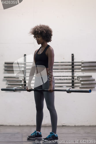 Image of black woman lifting empty bar