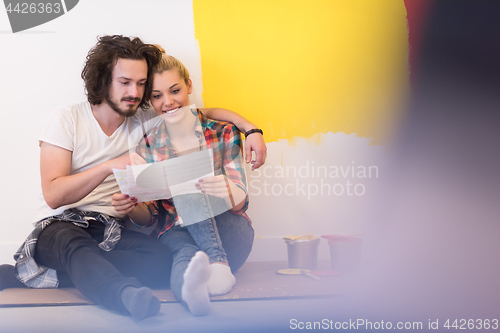 Image of Happy young couple relaxing after painting