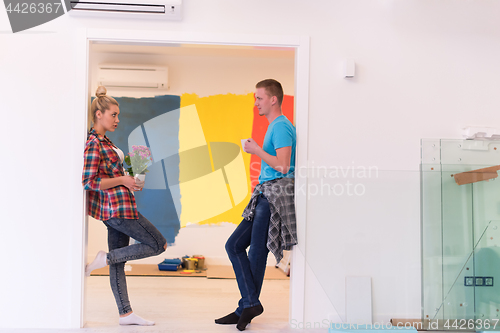 Image of multiethnic couple renovating their home