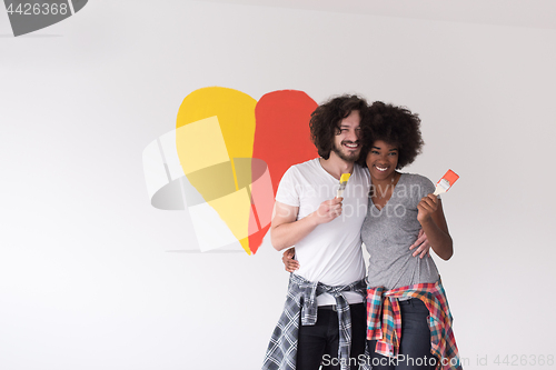 Image of couple with painted heart on wall