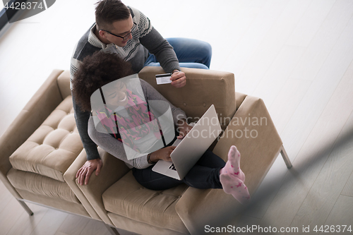 Image of multiethnic couple shopping online