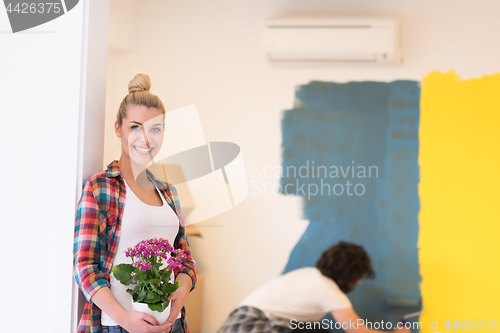 Image of happy young couple doing home renovations