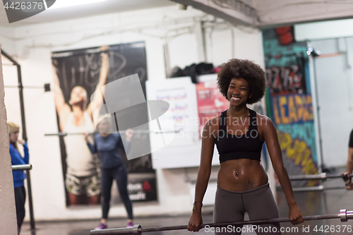 Image of black woman lifting empty bar