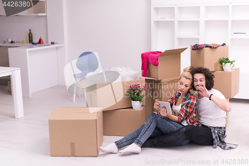 Image of young couple moving  in new house