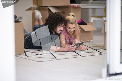 Image of Young couple moving in a new flat