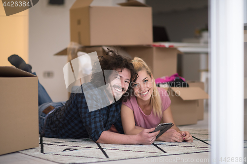 Image of Young couple moving in a new flat