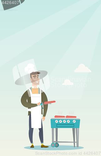 Image of Man cooking steak on barbecue grill.