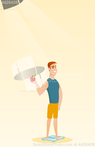 Image of Man standing on scale and holding apple in hand.