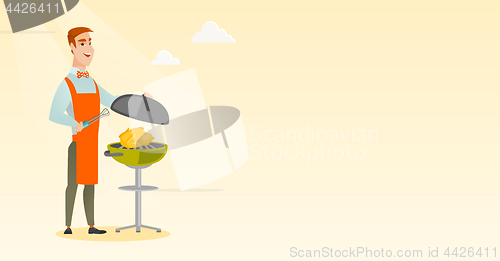 Image of Man cooking chicken on barbecue grill.
