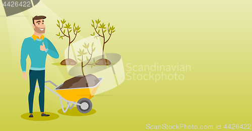 Image of Man pushing wheelbarrow with plant.