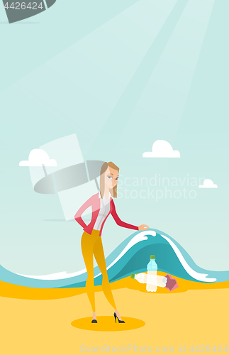 Image of Woman showing plastic bottles under sea wave.