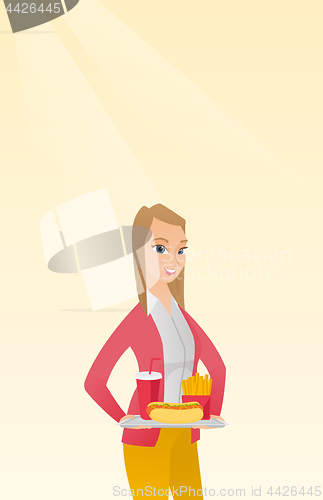 Image of Woman holding tray full of fast food.