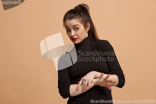 Image of Young woman with disgusted expression repulsing something, isolated on the pastel