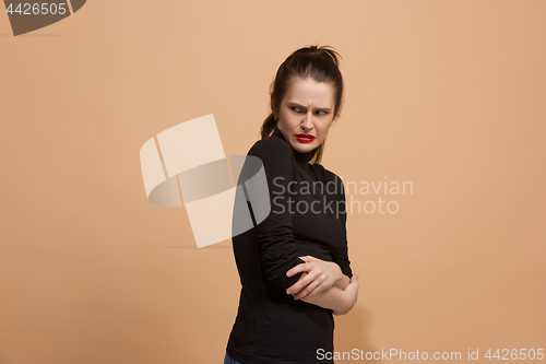 Image of Young woman with disgusted expression repulsing something, isolated on the pastel