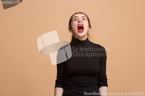 Image of The young emotional angry woman screaming on pastel studio background