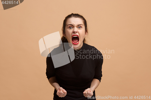 Image of The young emotional angry woman screaming on pastel studio background