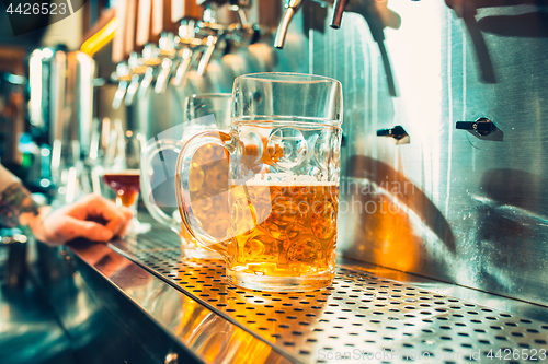 Image of Glass of beer with barrel, bottle and fresh hops still-life