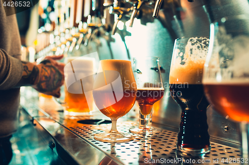 Image of Glass of beer with barrel, bottle and fresh hops still-life