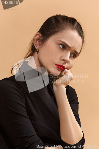 Image of Young serious thoughtful business woman. Doubt concept.