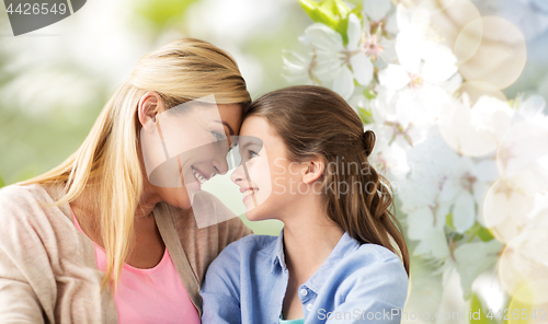 Image of happy mother and daughter over cherry blossom