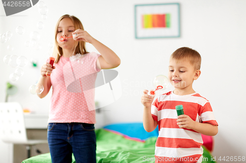 Image of kids blowing soap bubbles and playing at home