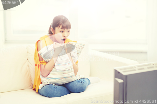 Image of asian young woman watching tv at home