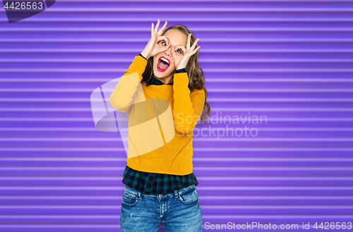 Image of happy young woman or teen girl making faces