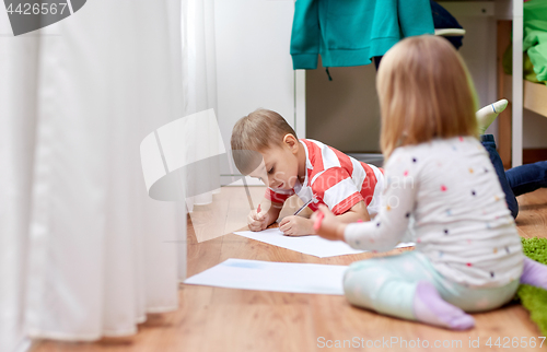 Image of happy kids drawing at home