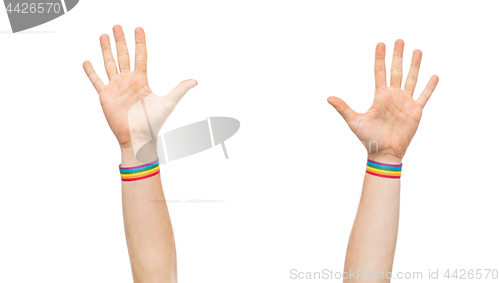 Image of hands with gay pride rainbow wristbands