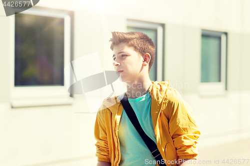 Image of teenage student boy walking outdoors