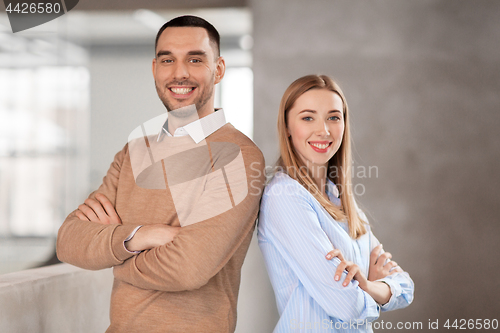 Image of smiling businesswoman and businessman at office