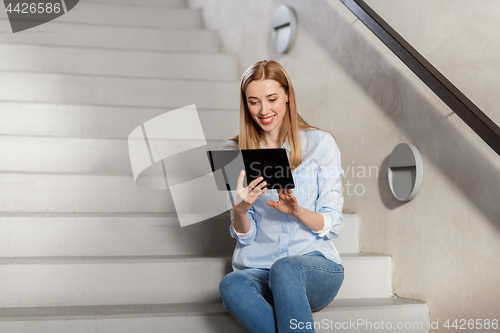 Image of woman or student with tablet pc sitting on stairs