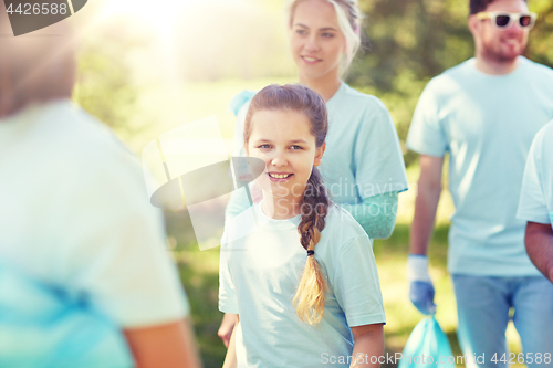 Image of volunteers with garbage bags outdoors