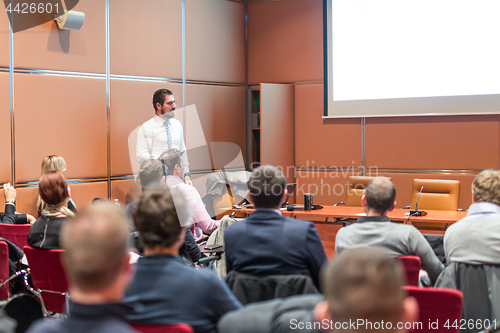 Image of Skiled Public Speaker Giving a Talk at Business Meeting.